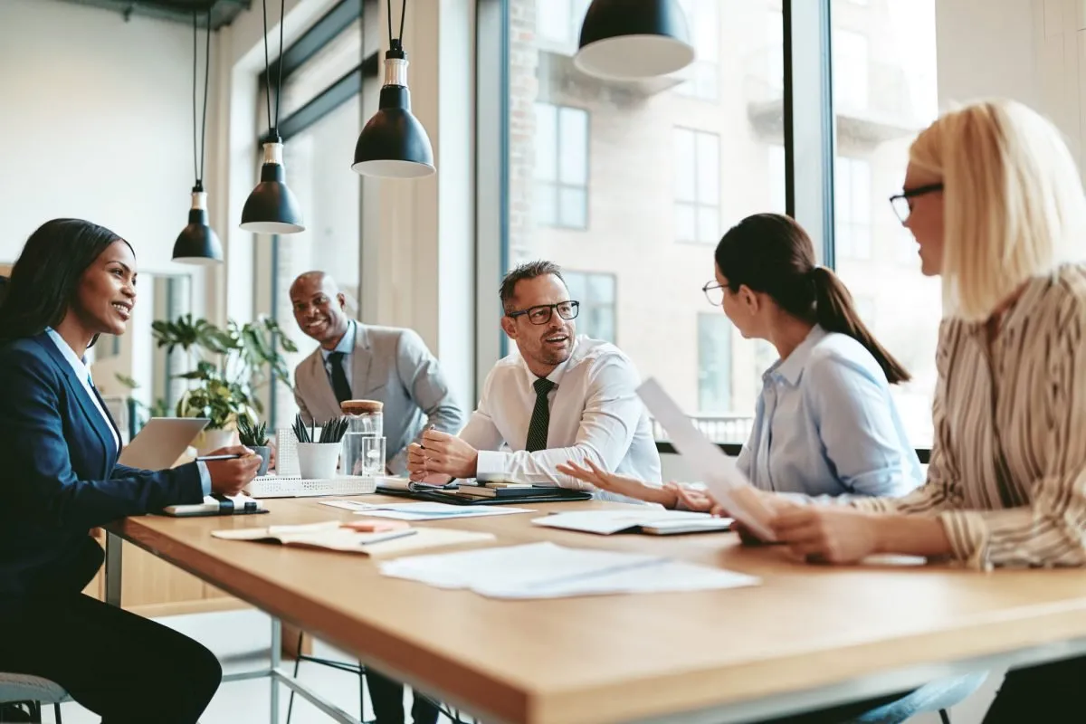 A team discussing a project around a meeting table