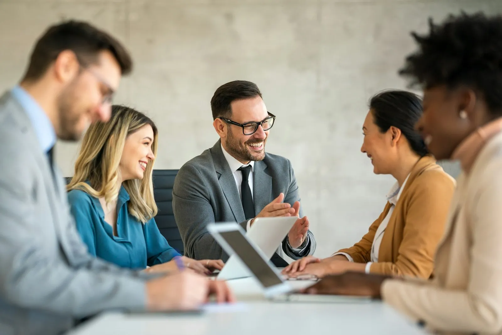 Business team discussing documents around a meeting table