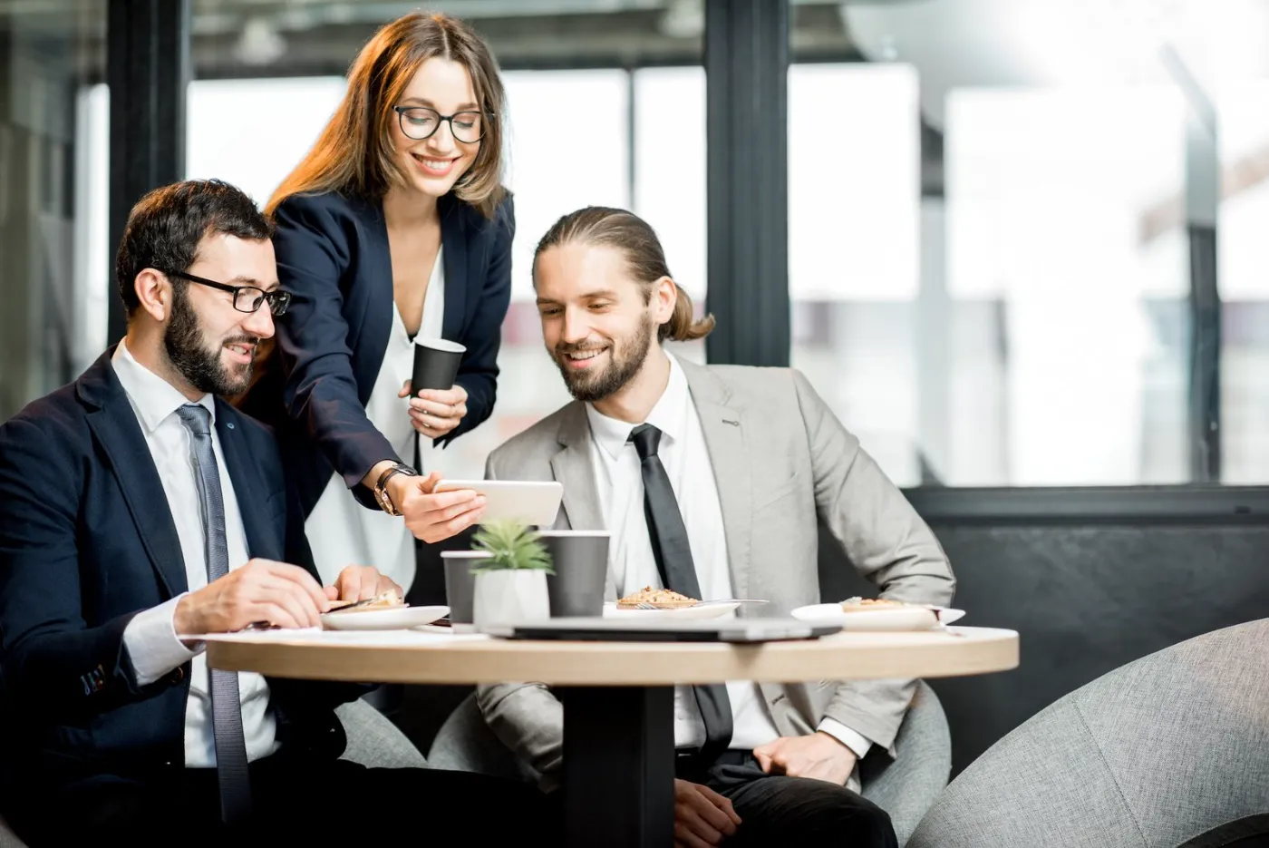 Three business people meeting at a cafe table