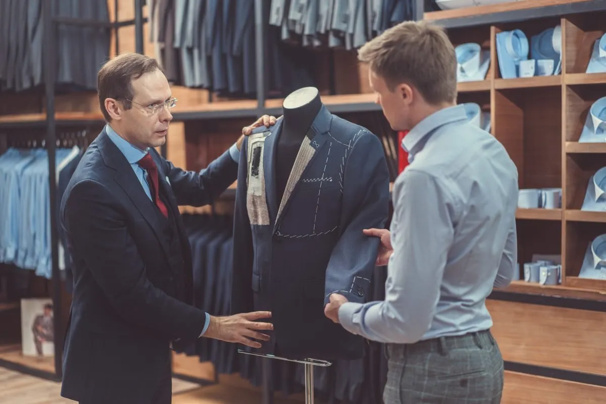 Tailor fitting a suit on a mannequin