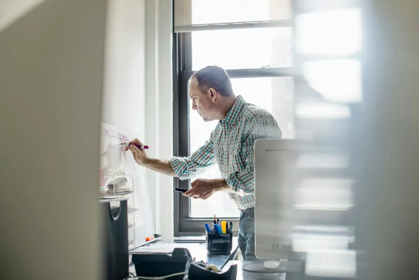 Man mapping ideas on a wall chart