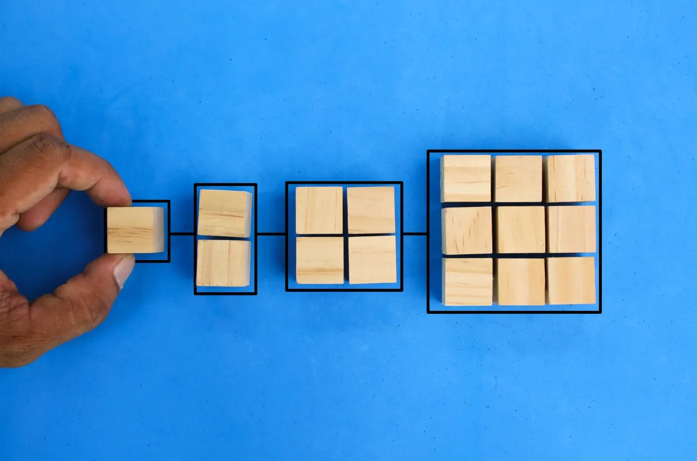Wooden blocks arranged in a growing grid