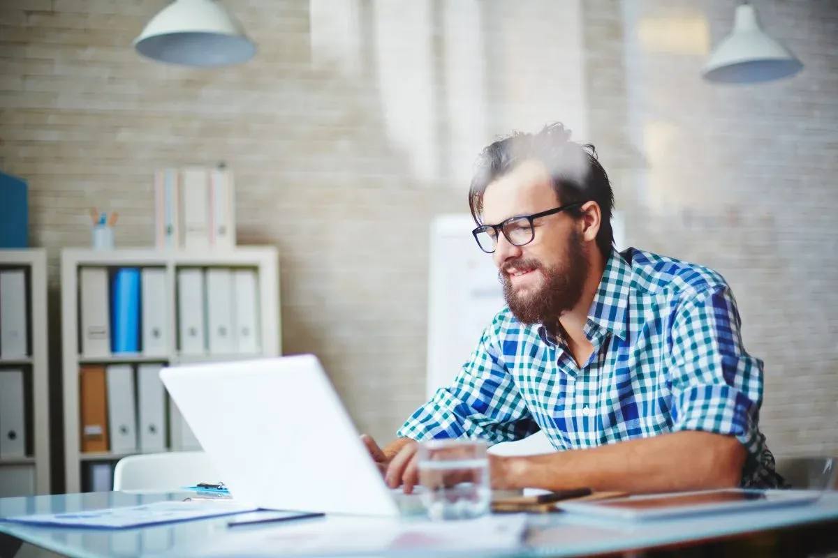 Man typing at a laptop