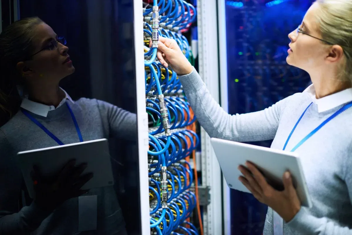 Engineer checking a server rack with a tablet