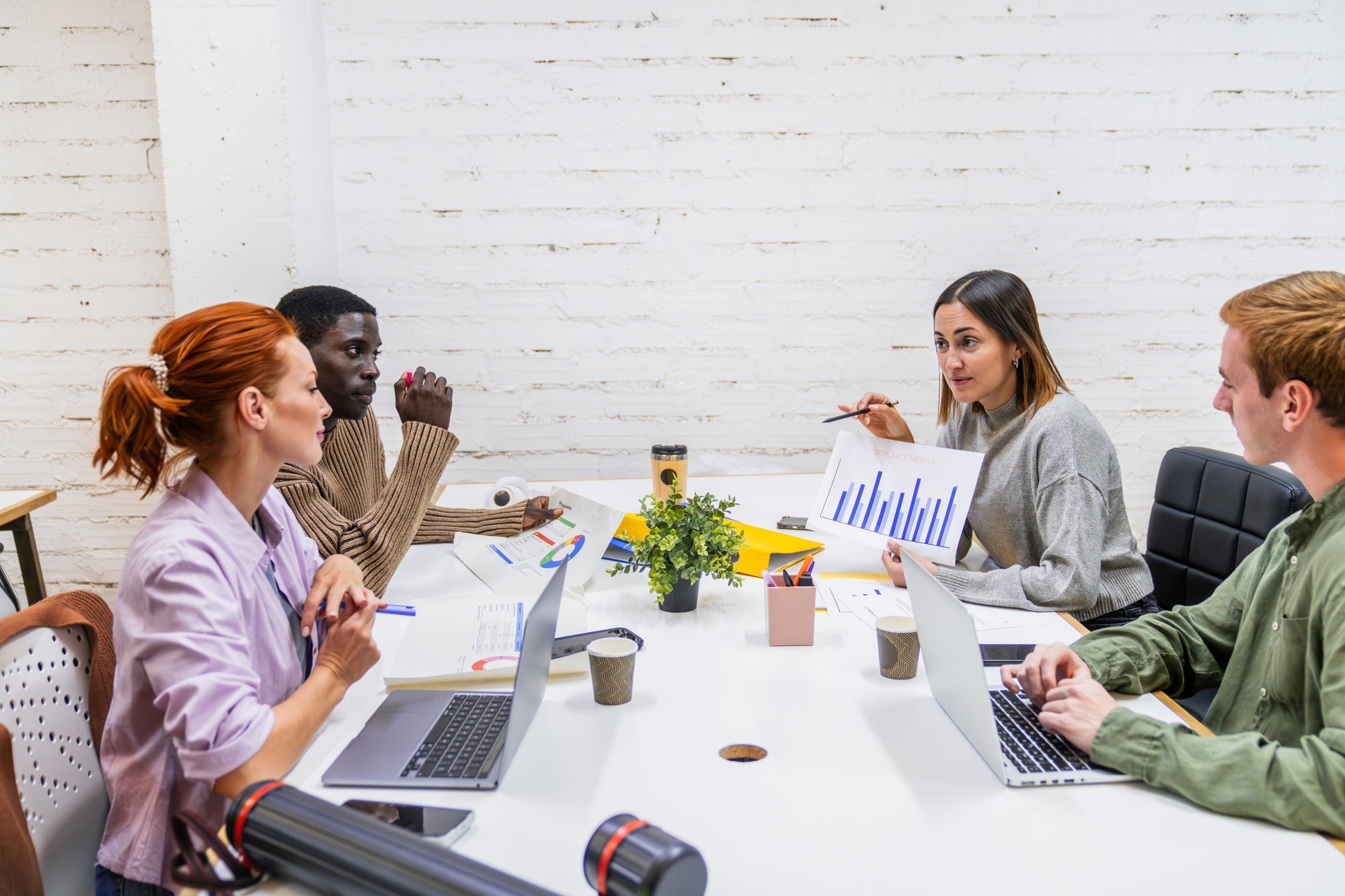 Marketing professionals discussing growth strategies in coworking space