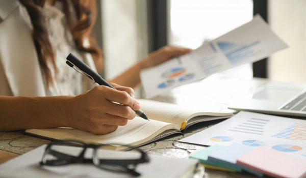 Business women are checking the company performance chart.