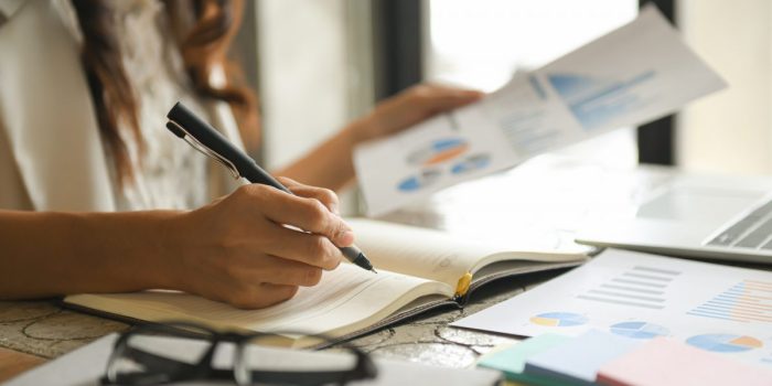Business women are checking the company performance chart.