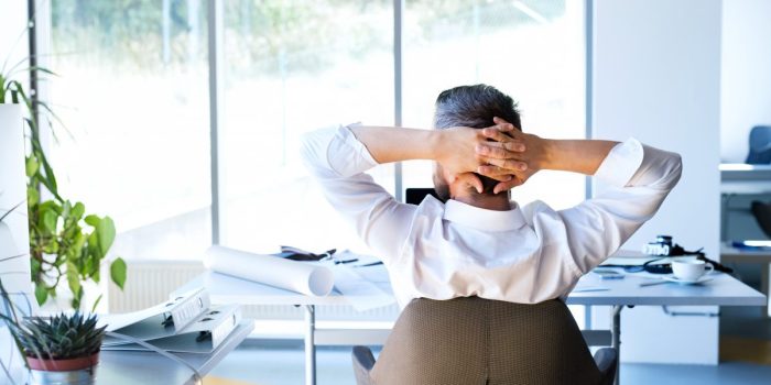 businessman-at-the-desk-in-his-office-resting-P2C76B3