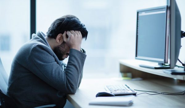Depressed upset office worker having a headache problem