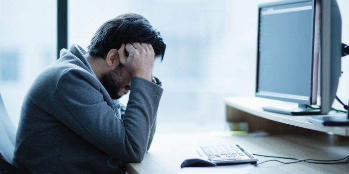 Depressed upset office worker having a headache problem