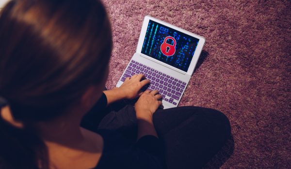 Female woman typing on locked smart device pad attacked by ransomware virus