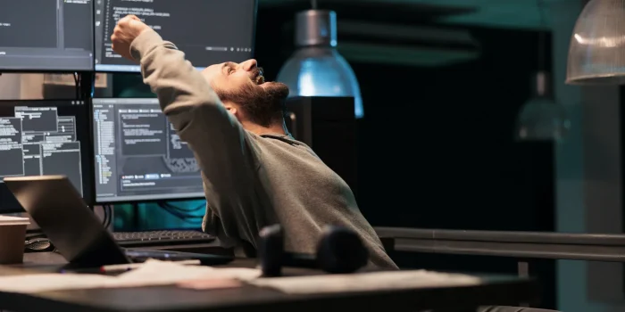 Pleased engineer celebrating ai software victory