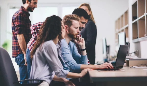 Programmers cooperating at information technology company