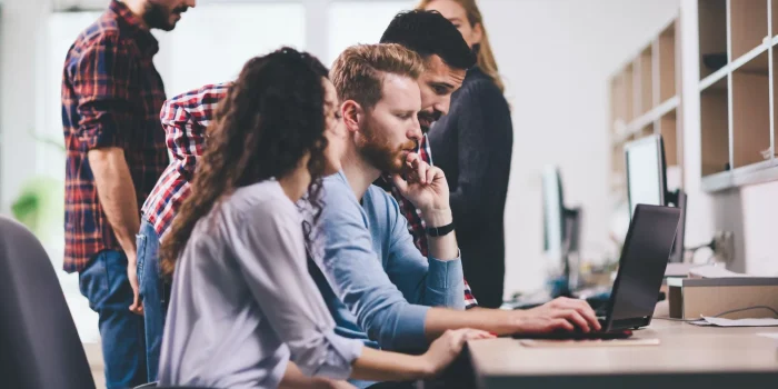 Programmers cooperating at information technology company