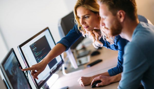 Software engineers working on project and programming in company