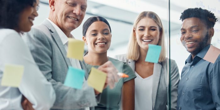 Teamwork, sticky notes or business team on a strategy, moodboard or storyboard in office. Corporate