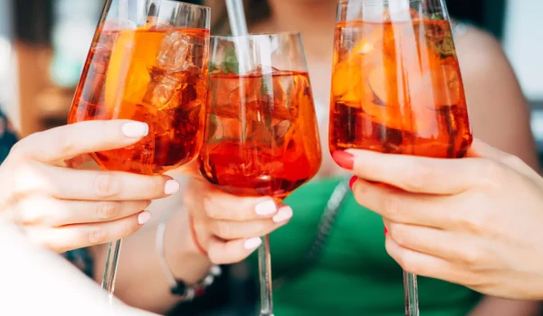 woman toasting with aperol spritz