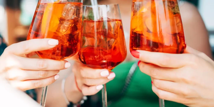 woman toasting with aperol spritz